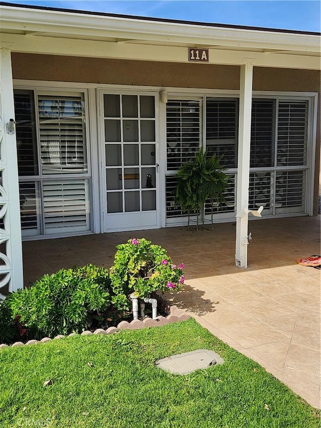 entrance to property featuring a patio