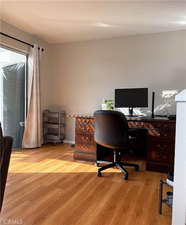 home office with light wood finished floors