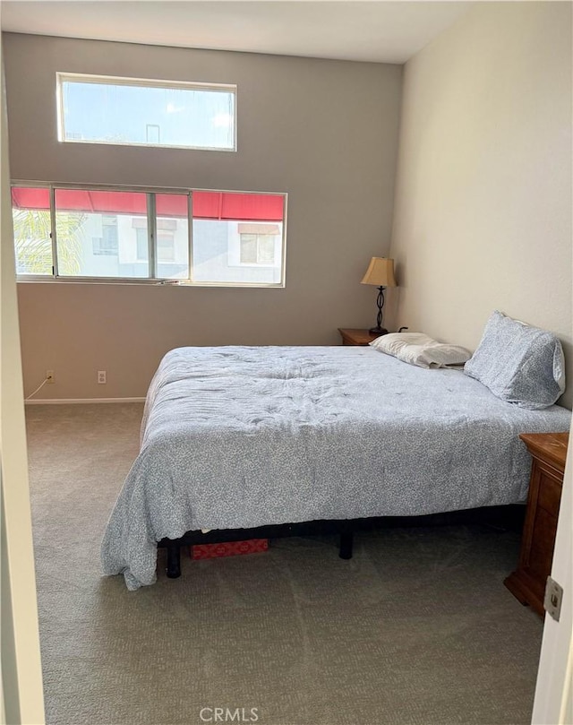 carpeted bedroom featuring baseboards