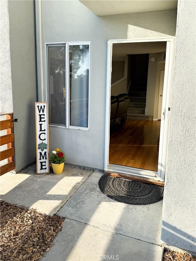 view of exterior entry featuring stucco siding