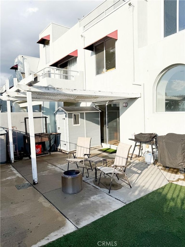 back of house featuring a patio area and stucco siding