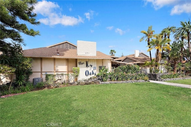 view of front of house featuring a front lawn and stucco siding