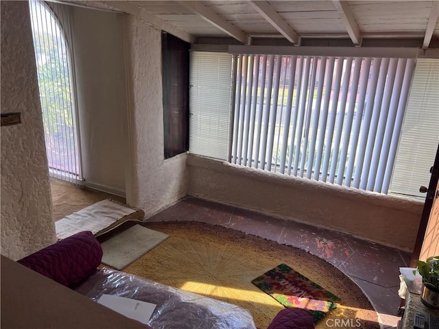 interior space featuring beamed ceiling