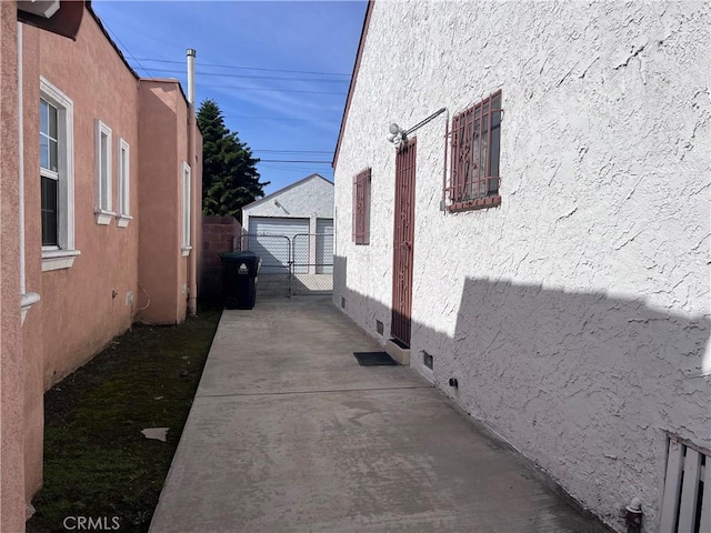 view of property exterior featuring a garage and an outbuilding