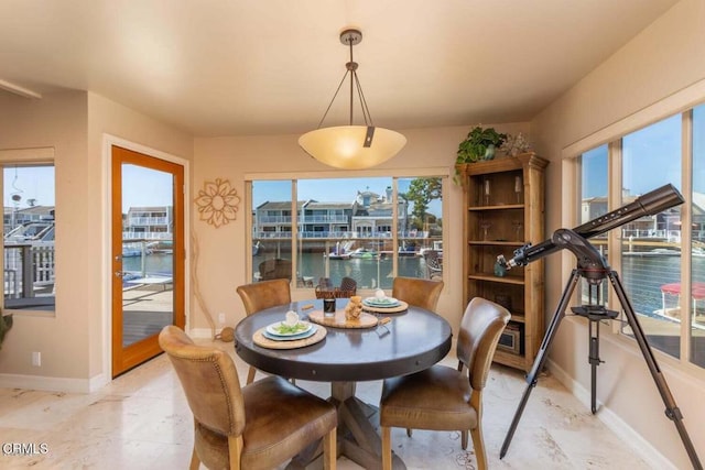 dining space featuring a water view and plenty of natural light