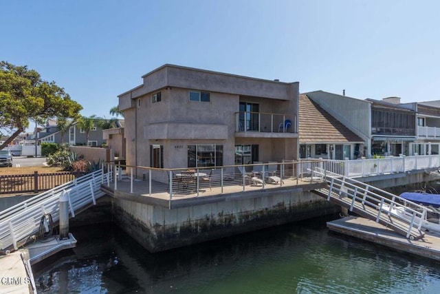 rear view of property featuring a water view