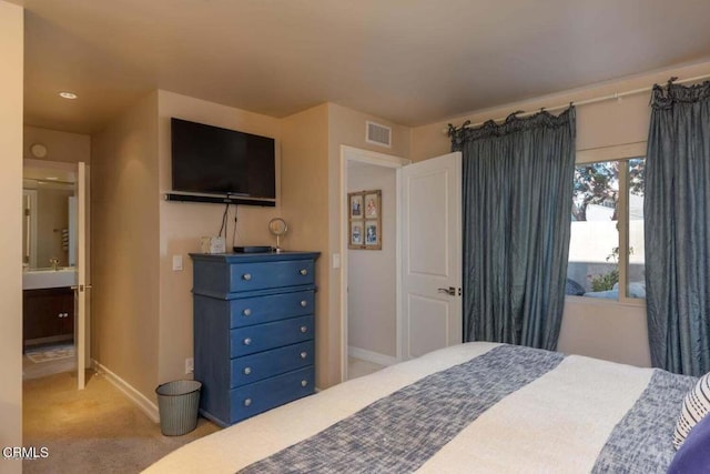 bedroom featuring light colored carpet and sink