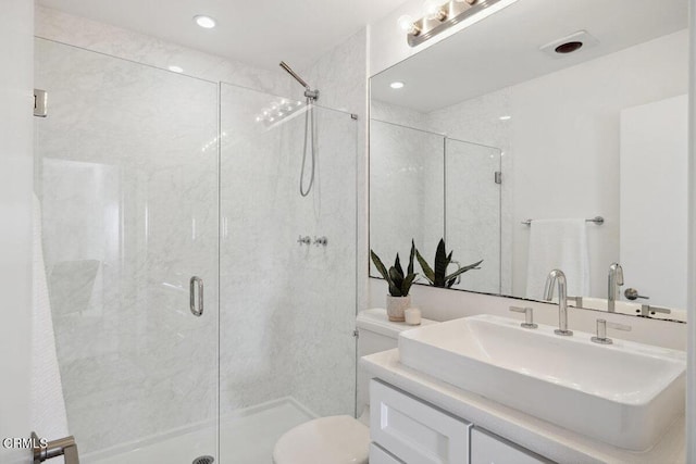 bathroom with vanity, an enclosed shower, and toilet