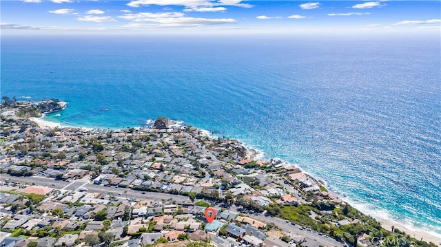 aerial view with a residential view, a water view, and a beach view