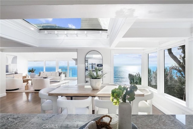 sunroom / solarium with beamed ceiling, a water view, and coffered ceiling