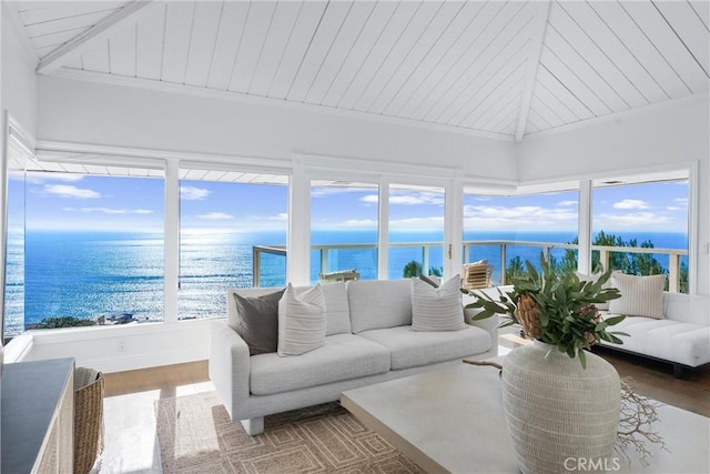 sunroom featuring vaulted ceiling, a water view, and plenty of natural light