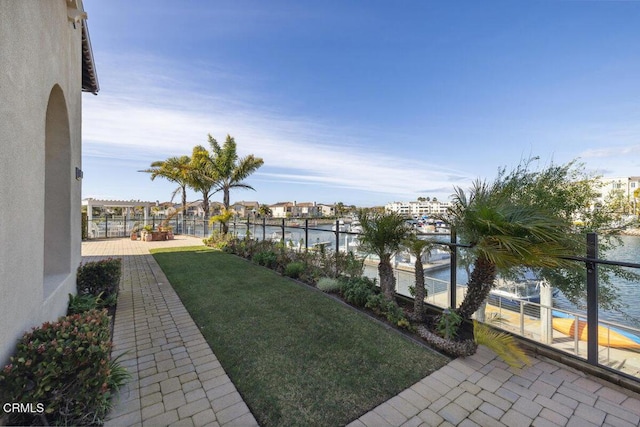 view of yard featuring a water view and a patio