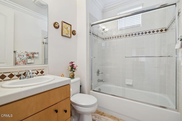 full bathroom with vanity, combined bath / shower with glass door, ornamental molding, and toilet