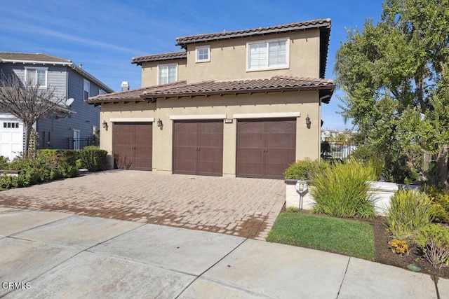 mediterranean / spanish-style home featuring a garage