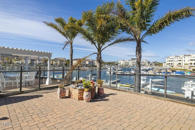 view of patio / terrace featuring a water view and a pergola