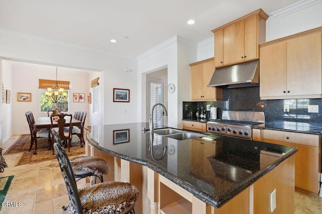 kitchen with pendant lighting, sink, ornamental molding, light brown cabinetry, and dark stone counters