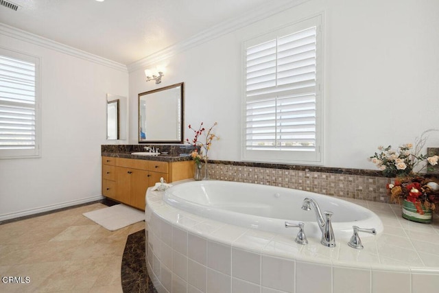 bathroom with tiled tub, crown molding, and vanity