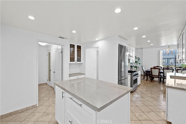 1223 Roxbury Dr Unit 305, Los Angeles, CA 90035 - kitchen featuring appliances with stainless steel finishes, light tile patterned floors, white cabinets, and recessed lighting