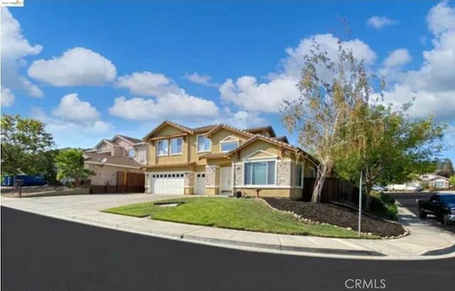 view of front of property with a front yard, a garage, and driveway