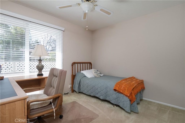 bedroom featuring light carpet and ceiling fan