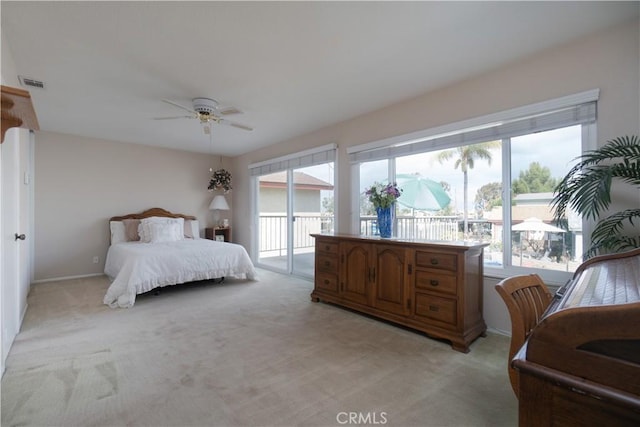 carpeted bedroom with access to exterior and ceiling fan