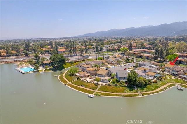 drone / aerial view featuring a water and mountain view