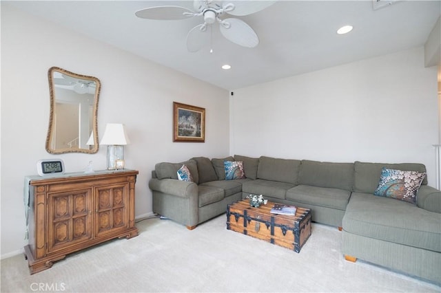 living room featuring light carpet and ceiling fan