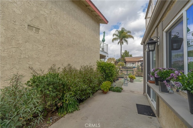 view of property exterior with a patio area