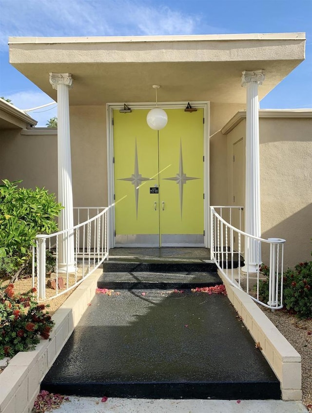 doorway to property with stucco siding