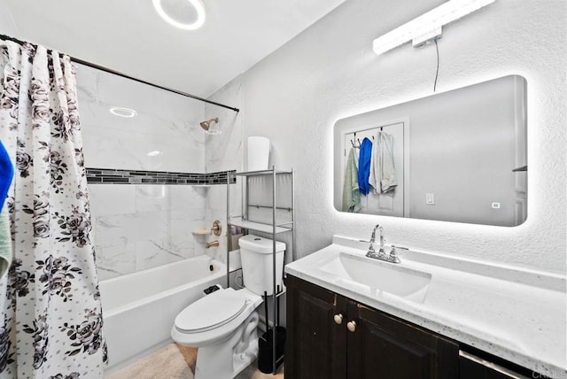 full bathroom with vanity, shower / bath combo, and toilet