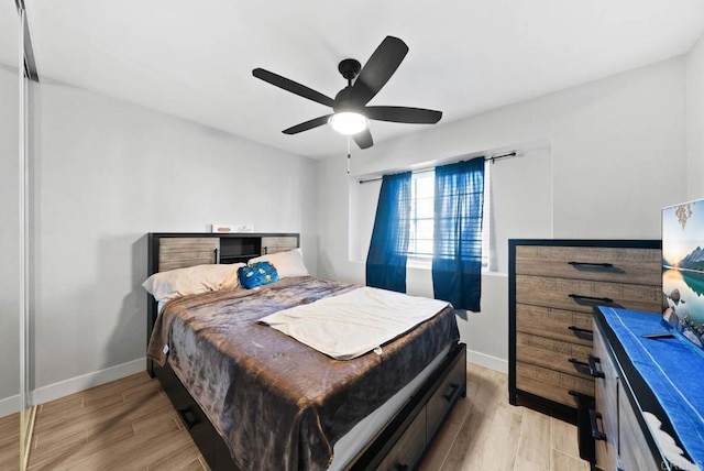 bedroom with ceiling fan and light hardwood / wood-style flooring