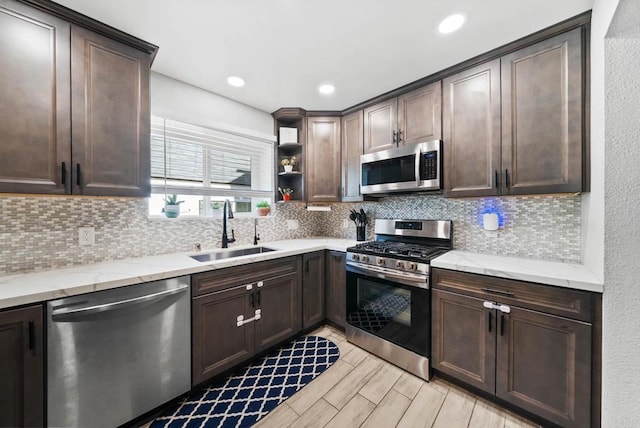 kitchen with dark brown cabinetry, sink, and appliances with stainless steel finishes