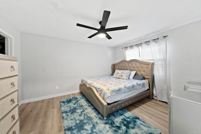 bedroom with light hardwood / wood-style flooring and ceiling fan