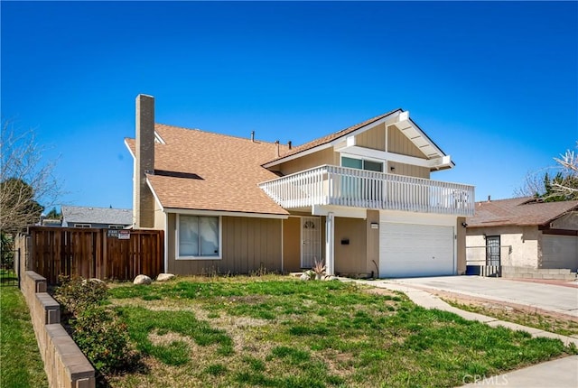 view of front of home featuring a garage, a balcony, and a front yard