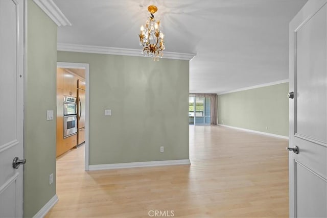 32709 Seagate Dr Unit 101, Rancho Palos Verdes, CA 90275 - unfurnished room with crown molding, light wood-type flooring, a chandelier, and baseboards