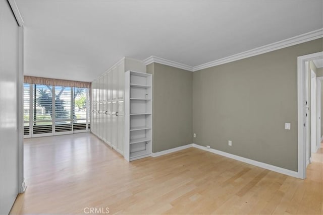 32709 Seagate Dr Unit 101, Rancho Palos Verdes, CA 90275 - empty room featuring light wood-style floors, baseboards, and crown molding