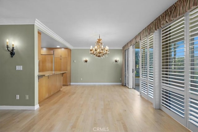 32709 Seagate Dr Unit 101, Rancho Palos Verdes, CA 90275 - unfurnished dining area featuring crown molding, baseboards, a chandelier, and light wood finished floors