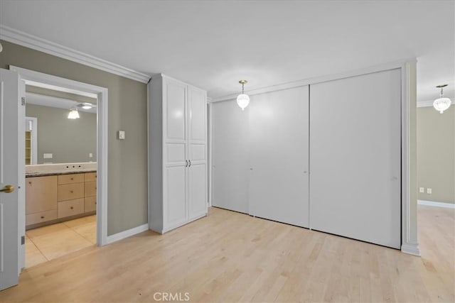 32709 Seagate Dr Unit 101, Rancho Palos Verdes, CA 90275 - unfurnished bedroom with crown molding, light wood-type flooring, a closet, baseboards, and ensuite bathroom
