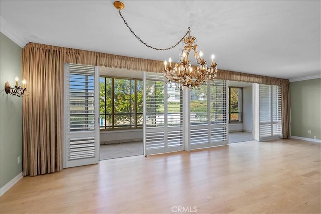 32709 Seagate Dr Unit 101, Rancho Palos Verdes, CA 90275 - unfurnished dining area with a chandelier, wood finished floors, baseboards, and ornamental molding