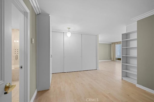 32709 Seagate Dr Unit 101, Rancho Palos Verdes, CA 90275 - empty room featuring crown molding, light wood-style flooring, and baseboards