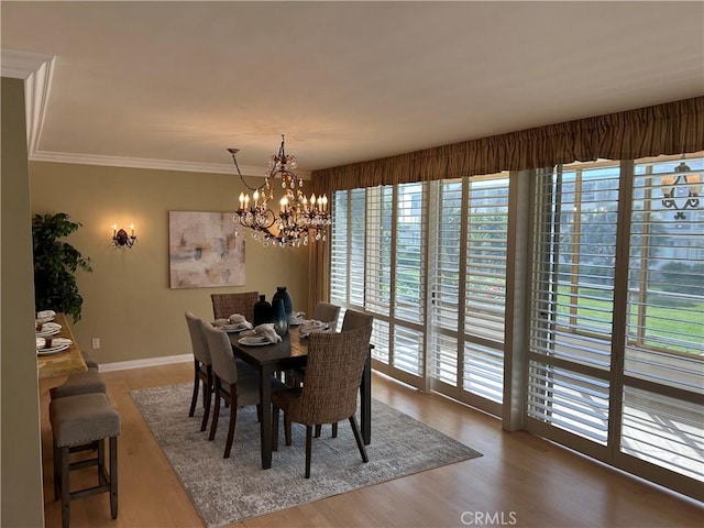 32709 Seagate Dr Unit 101, Rancho Palos Verdes, CA 90275 - dining room featuring a chandelier, wood finished floors, crown molding, and baseboards