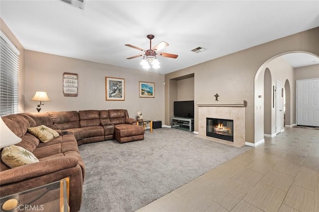 living room with a ceiling fan, carpet, visible vents, and baseboards