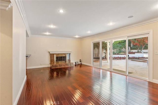 unfurnished living room featuring hardwood / wood-style flooring, crown molding, and a premium fireplace