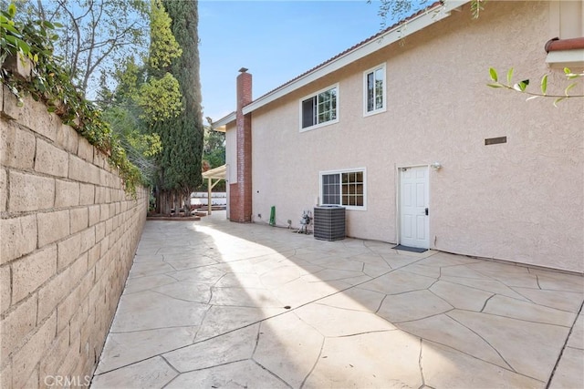 1885 Fallview Rd, Westlake Village, CA 91361 - back of property with stucco siding, a patio, and a chimney
