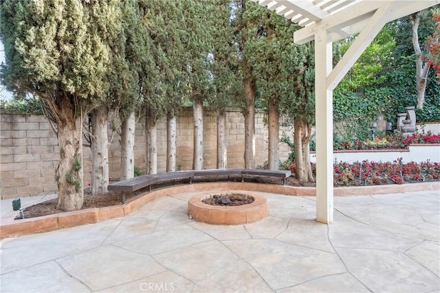 view of patio / terrace with a pergola and a fire pit