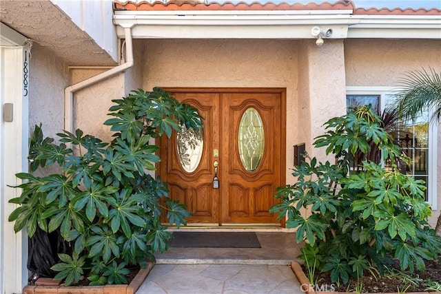 1885 Fallview Rd, Westlake Village, CA 91361 - view of exterior entry featuring a tile roof and stucco siding