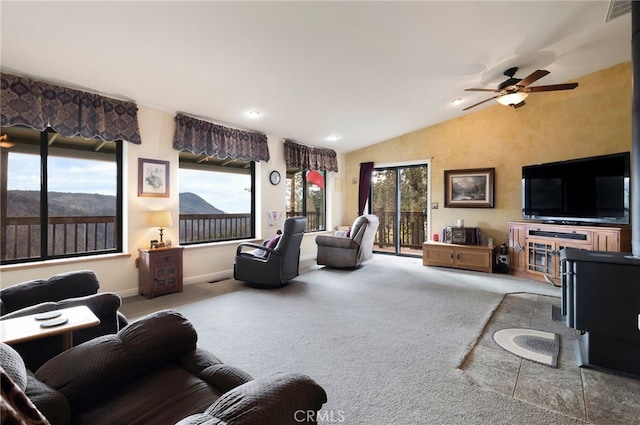 living room with lofted ceiling, a mountain view, ceiling fan, and carpet