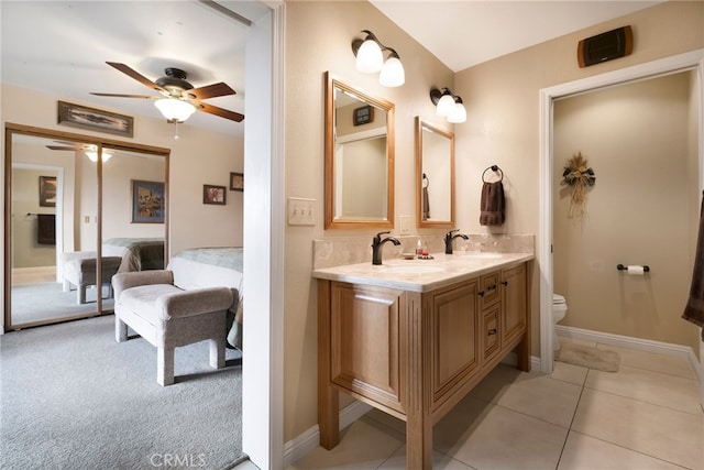 bathroom featuring decorative backsplash, vanity, ceiling fan, toilet, and tile patterned floors