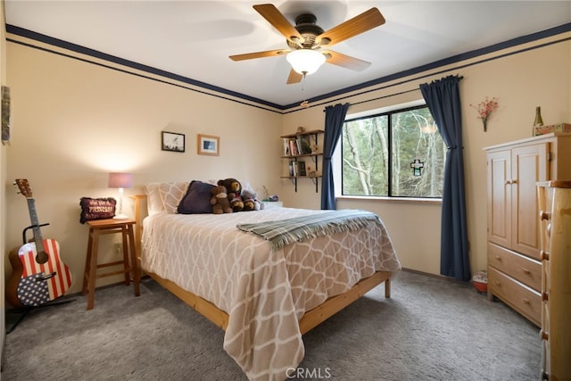 bedroom featuring crown molding, ceiling fan, and dark colored carpet