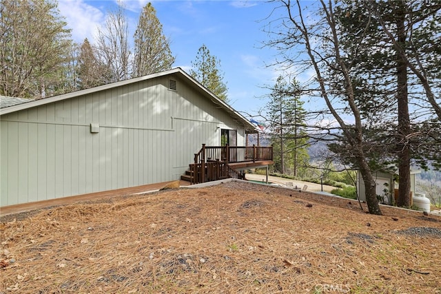 view of home's exterior with a wooden deck